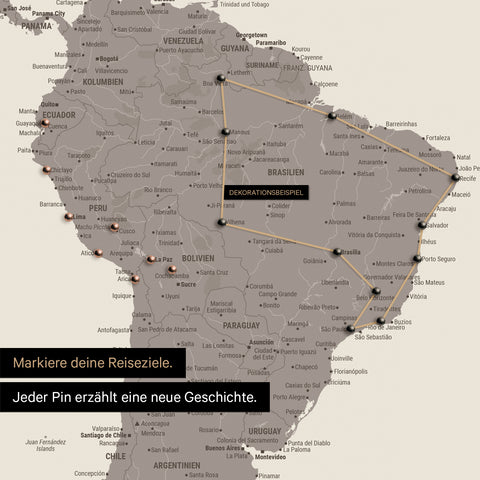 Dettaglio di una mappa del mondo come Mappa da puntine in Warmgray (marrone-grigio) con puntine che mostrano un itinerario di viaggio tracciato in Sud America attraverso i paesi Brasile, Perù ed Ecuador