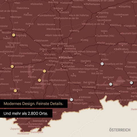 Ausschnitt einer magnetischen Deutschland-Karte in Bordeaux Rot zeigt Karte von Bayern, auf der Magnete Reiseziele markieren