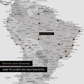 Dettaglio di una mappa del mondo come Mappa da puntine multicolore grigia con puntine che mostrano un itinerario di viaggio tracciato in Sud America attraverso i paesi Brasile, Perù ed Ecuador